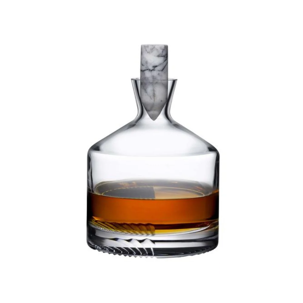 Elegant whiskey carafe with a sleek, modern design, featuring a marble stopper and a partially filled glass base showcasing its refined craftsmanship. Includes the Revolucion Cigars & Fine Gifts logo.